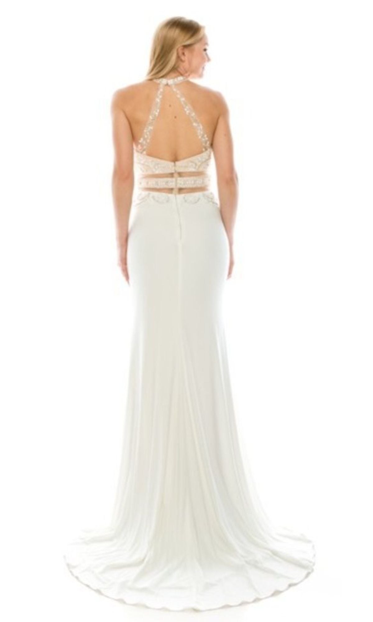 A woman in the Chicas CR7001 Faux Two-Piece Long Prom Dress, featuring a white floor-length design with a halter neckline, open back, lace straps, and sheer panel details.